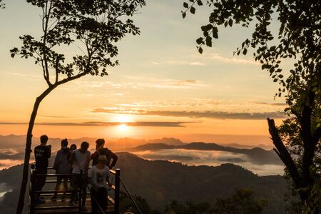 landscape sunset sunrise bright colors,  beautiful sky with sun over silhouette of treeの写真素材