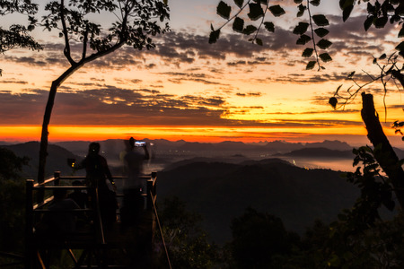 landscape sunset sunrise bright colors,  beautiful sky with sun over silhouette of treeの写真素材