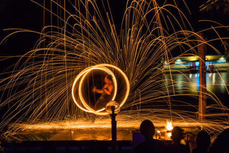 Fire dancing show fireball show amazing at night. Swinging fire in full moon thailand.