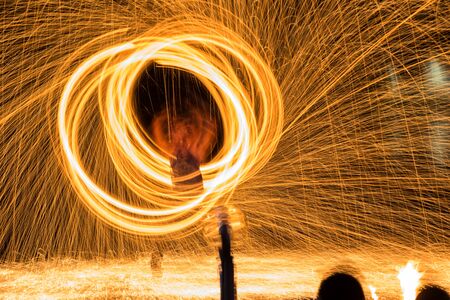 Fire dancing show fireball show amazing at night. Swinging fire in full moon thailand.の写真素材