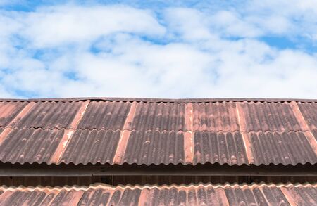 Old wooden house and blue sky background with tiny cloudsの写真素材