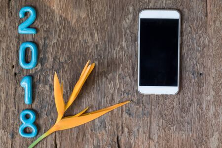 ceramic numbers forming the number 2018, For the new year 2018 on a old wooden background.の写真素材