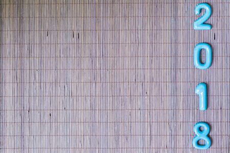 ceramic numbers forming the number 2018, For the new year 2018 on a wooden background.の写真素材