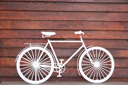 white bike on wooden background.Cycling or commuting in city urban environment, ecological transportation concept.の写真素材