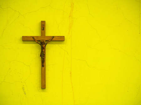 christian cross hung on a cracked wallの写真素材