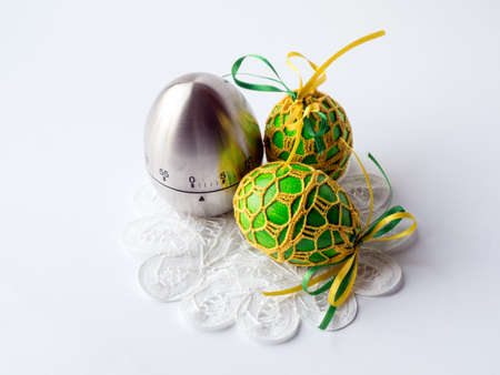 easter eggs prepared for the holidays and a timerの写真素材