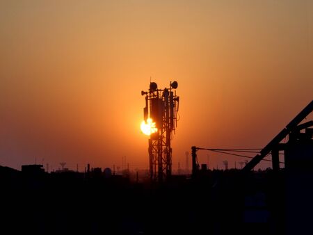 silhouette of mobile network tower and cityscapeの写真素材