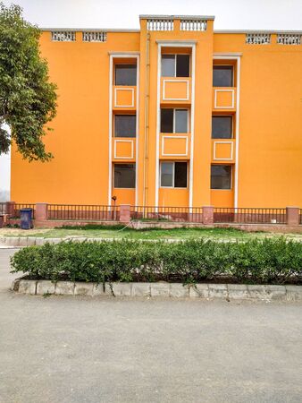 Orange colored house in the city with multiple parallel windowsの写真素材