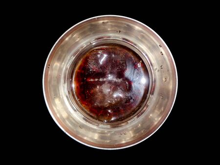 Top angle view of scotch whiskey in the glass isolated on black backgroundの写真素材