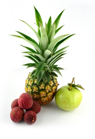 Fruit still life with pineapple apples guava and lychee on white backgroundの写真素材