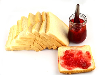 Rusk with strawberry jam on white backgroundの写真素材
