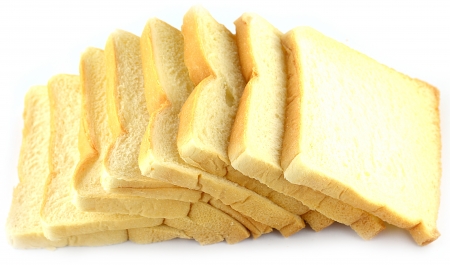 The cut loaf of bread on white backgroundの写真素材