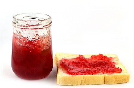 Rusk with strawberry jam on white backgroundの写真素材