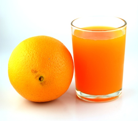 Orange juice and slices of orange isolated on white の写真素材