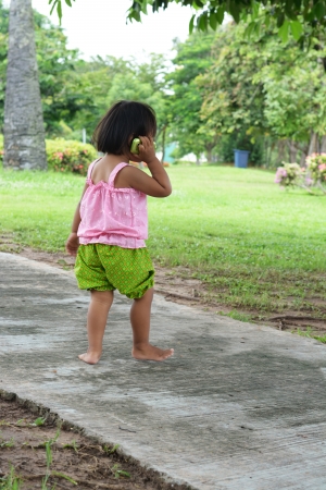 Little girl on the mobile phone の写真素材