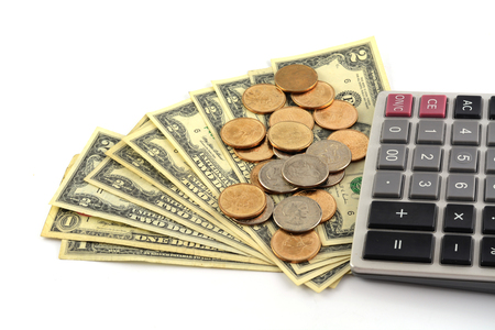 coins on dollars with caculatorの写真素材