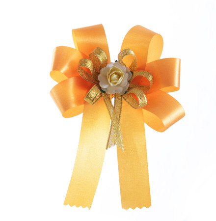 yellow bow ribbon isolated on whiteの写真素材