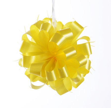 yellow bow ribbon isolated on whiteの写真素材
