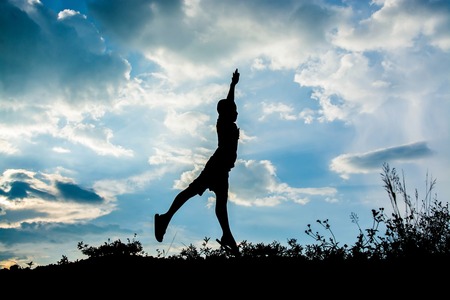 Little boy jumping to sky , Sillhouette conceptの写真素材