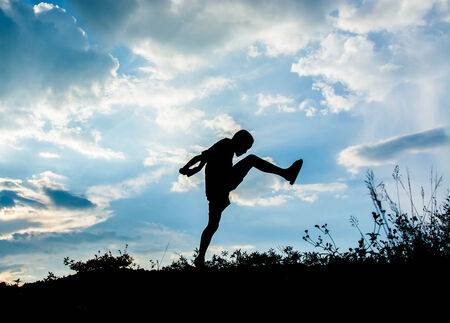 Little boy jumping to sky and having happy time, Sillhouette conceptの写真素材