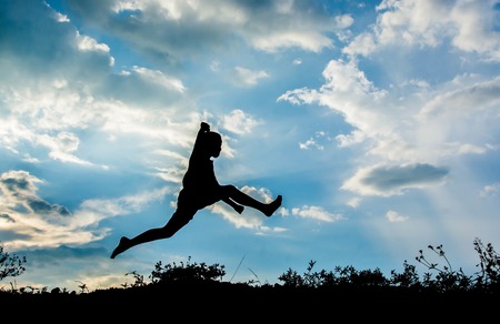 Little boy jumping to sky and having happy time, Sillhouette conceptの写真素材