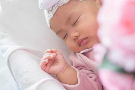 Sleeping baby on pink background
