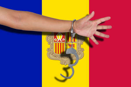 handcuffs with hand on Andorra flagの写真素材