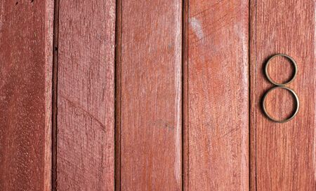 Wedding rings on wooded backgroundの写真素材