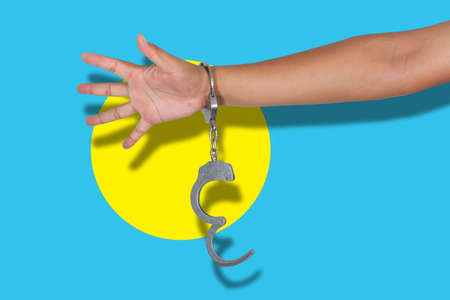 handcuffs with hand on Palau flagの写真素材