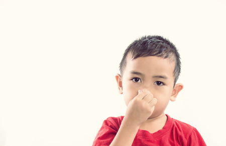 kid holding his nose