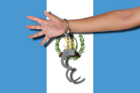 handcuffs with hand on flagの写真素材