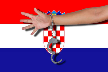 handcuffs with hand on Croatia flagの写真素材