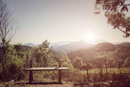 Wooden bench with beautiful mountain viewの写真素材