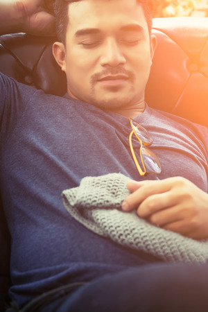 handsome hipster man take a nap on his sofa in the houseの写真素材