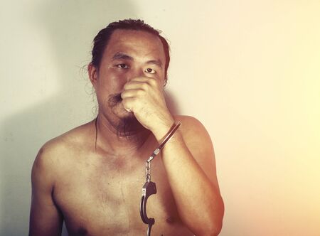 portrait of a man prisoner with handcuffの写真素材