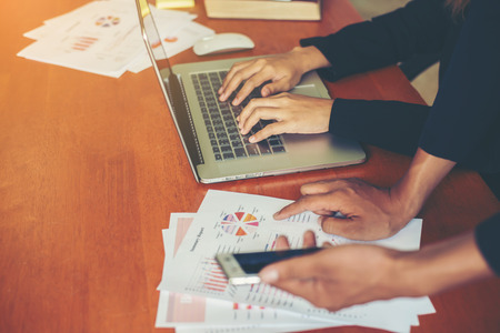 Business team working on laptop, while sitting at office. Business people.の写真素材