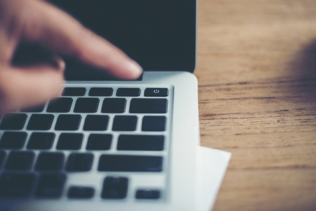 Woman hands finger point pushing into shutdown buttonの写真素材