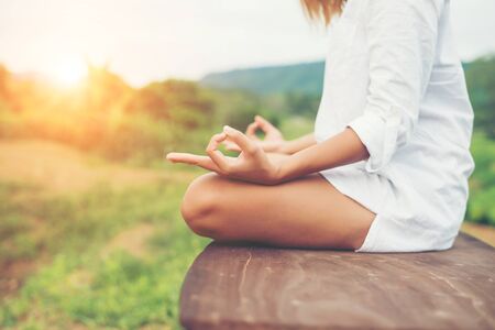 Woman hands yoga meditations and making a zen symbol with her hand.の写真素材