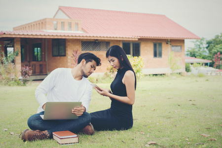 Young education couple was reading in the outdoors and good weather. And they're happy, Lifestyle concept.
の写真素材