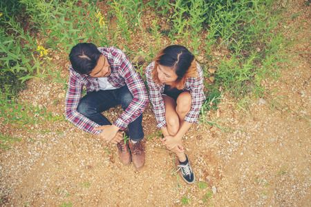 Young happy hipster couple sitting in the yellow field,Dating enjoying time together.の写真素材