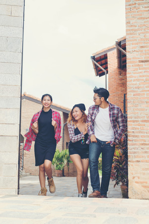 Summer holidays and hipster teenagers group traveling together in urban town having fun and happy time together.の写真素材