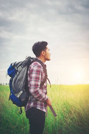 Hipster man with a backpack on his shoulders,time to go traveling,tourism concept.の写真素材