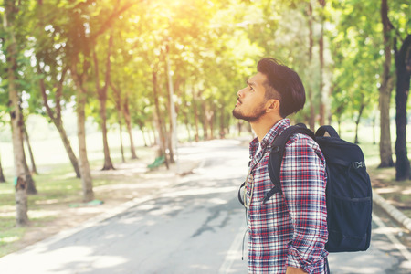 Close up side of hipster young traveler man looking to the nature, enjoying with fresh weather.