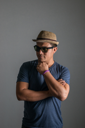 Handsome hipster men wearing hat and glasses posing in studio isolated on white background.の写真素材