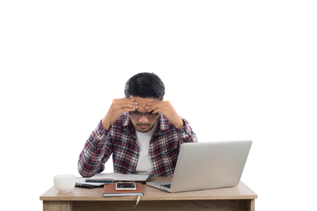 Worried businessman lamenting in front of a computer after got mistake at office.の写真素材