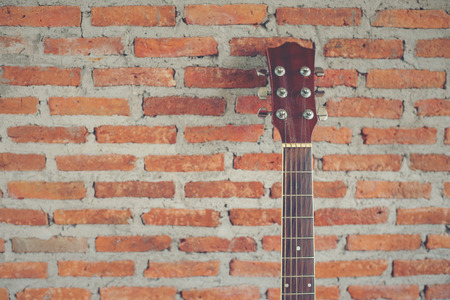 classical guitar with brick background horizontalの写真素材