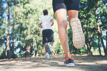 Young couple running in the park.の写真素材