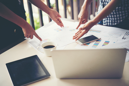 Business people at work on stock market charts in office. Meeting working analysis concept.の写真素材