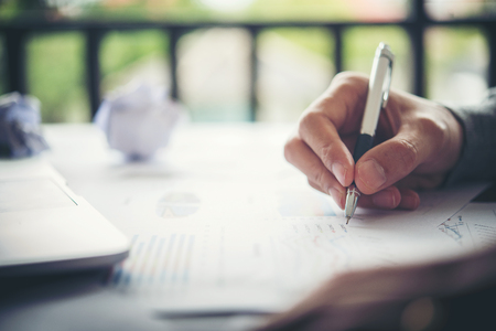 Business Woman Writing with pen in notepad, working woman concept.の写真素材