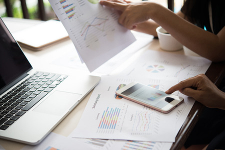 Business people at work on stock market charts in office. Meeting working analysis concept.の写真素材